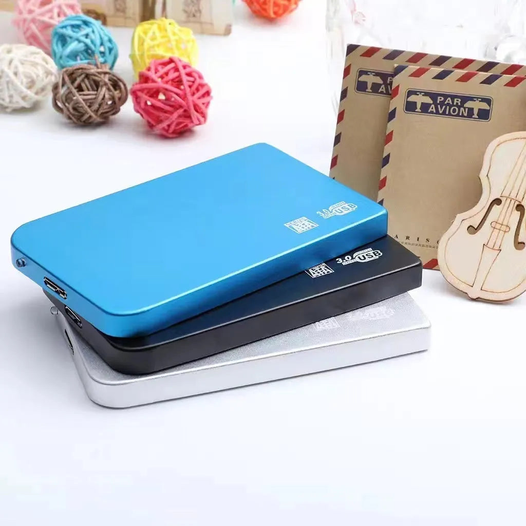 Black USB 3.0 portable solid state drive with metal housing on a desk.