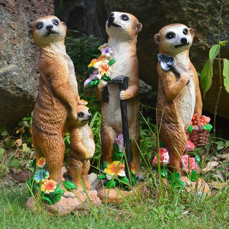 Three straw hat mongoose resin ornaments: mother and son, with rake, and with shovel figurines.