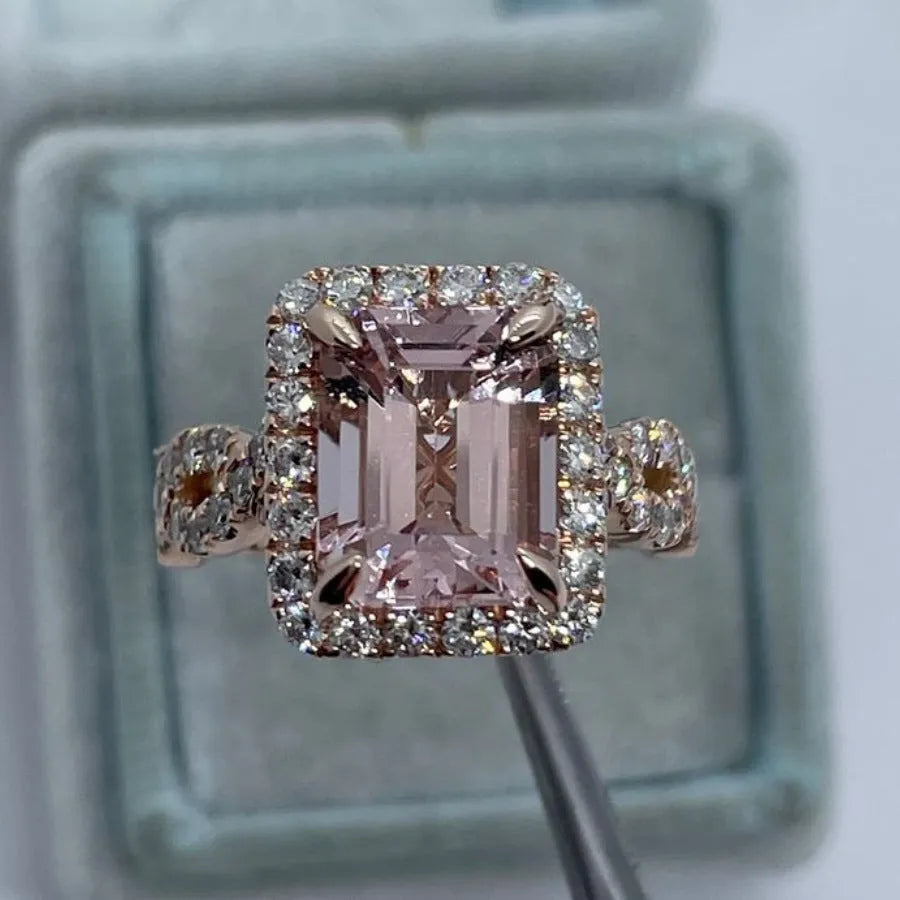 Geometric rose gold alloy ring on a plain background showing its shape and electroplated finish.