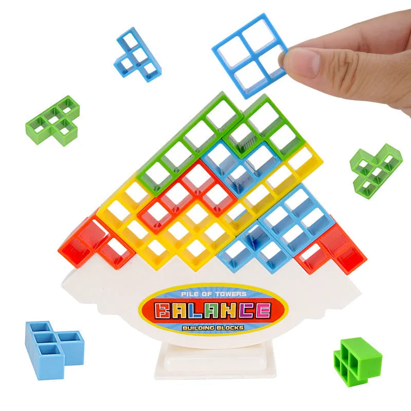 Plastic balance stacking game with 16 coloured blocks, chassis, and base on a table.