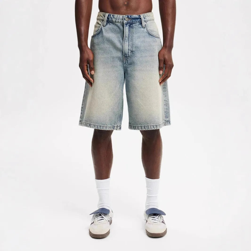 Men's loose fit straight leg jeans in light blue denim with traditional cotton construction