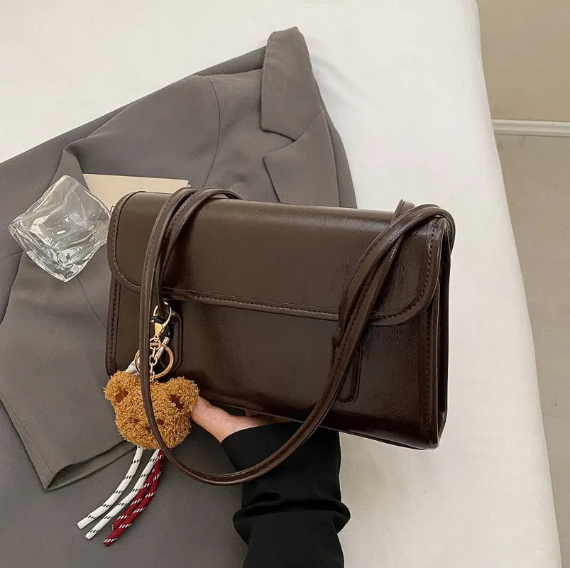 Women's brown PU Maillard shoulder bag with pendant showing horizontal square shape and dual straps