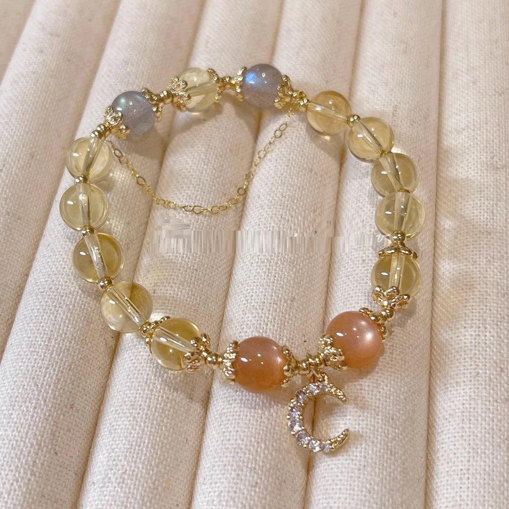Gold electroplated women's crystal bracelet with diamond shape and fortune charm.