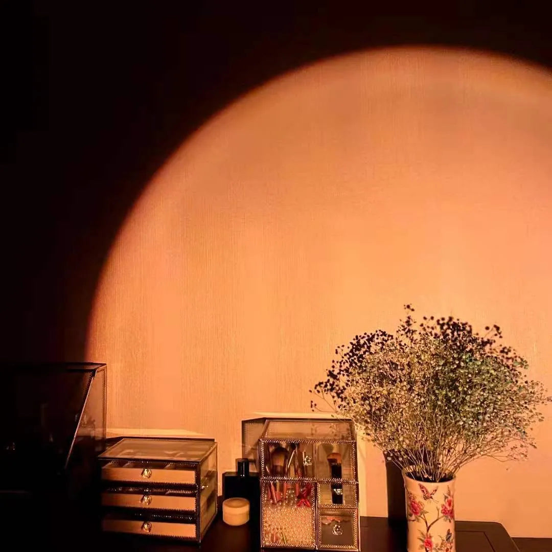 Rechargeable sunset red rainbow projection lamp with USB cable on tabletop