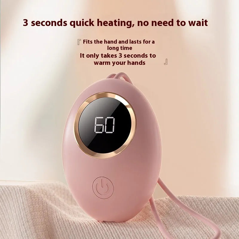 Compact USB rechargeable hand warmer power bank with digital display, shown in pink colour.