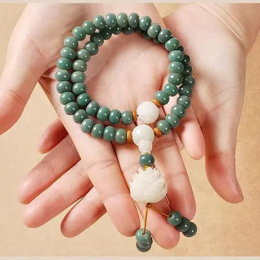 Bodhi seed beaded bracelet with a double ring safety buckle clasp featuring a Lotus detail.