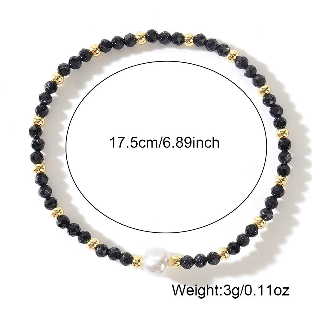 A natural stone bracelet with a geometric ellipse shape on a wrist.