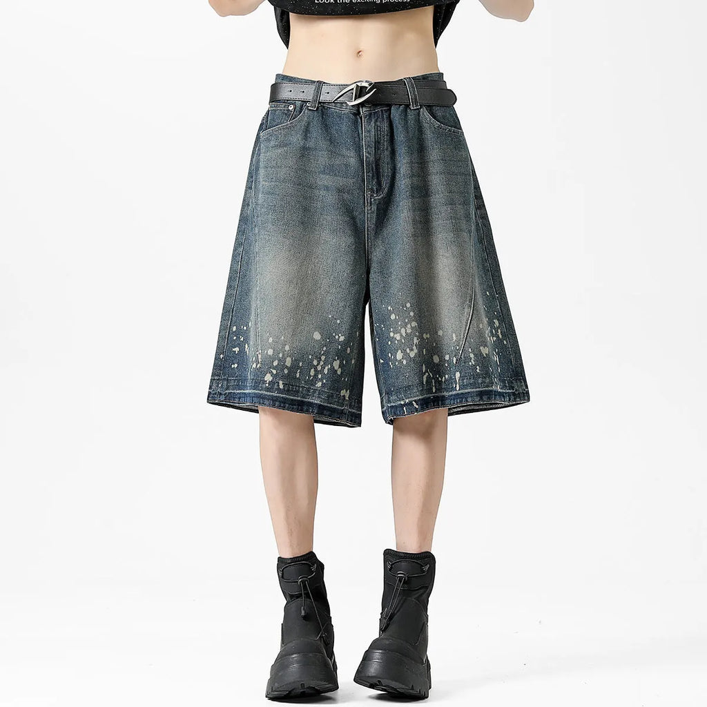 Men's retro blue washed denim shorts with ripped and splash ink distressing detail on straight-leg cut