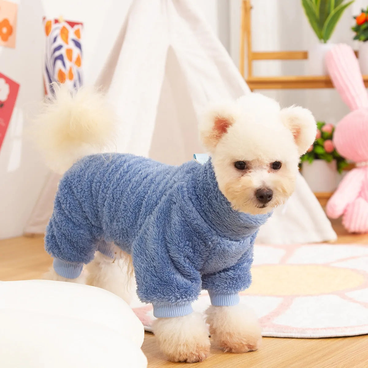 Blue double-sided plush dog clothes with high collar and towing ring on a mannequin.