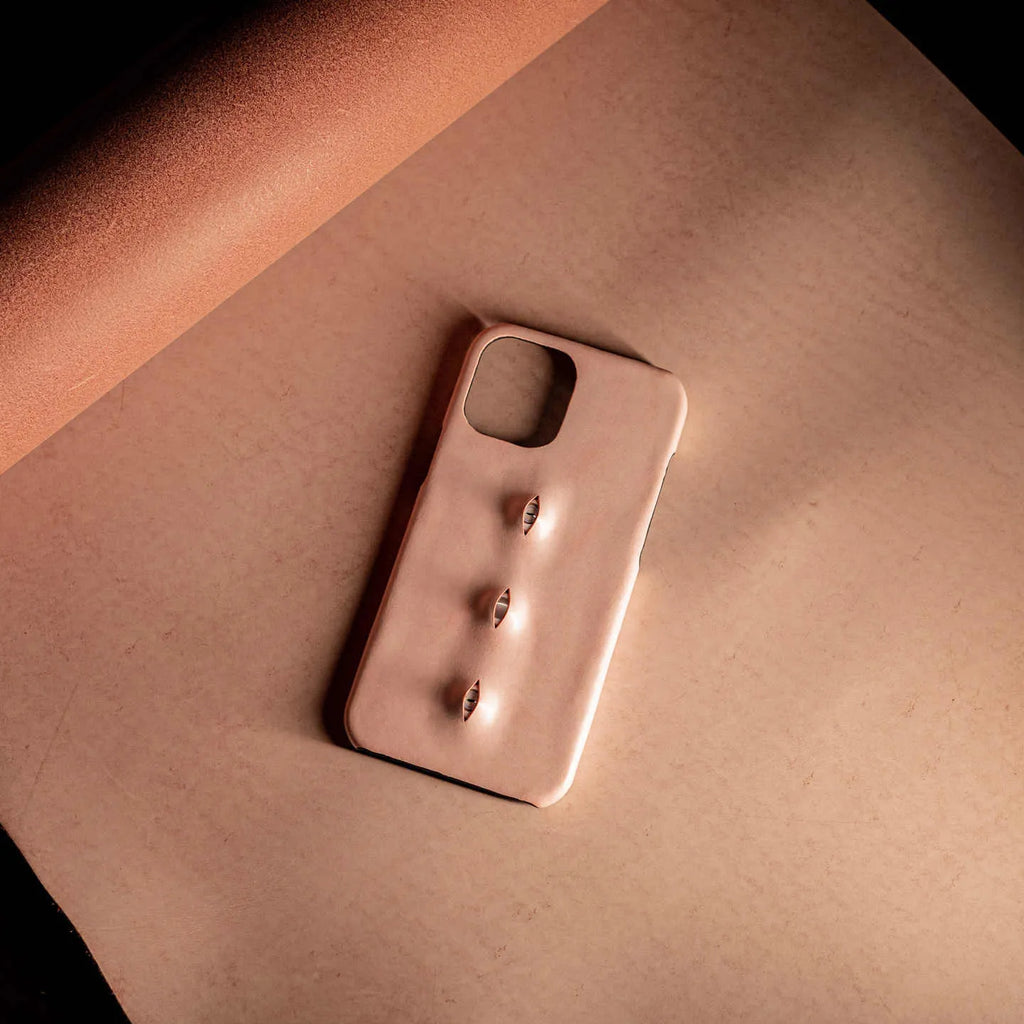Pink eye-shaped handmade iPhone case in waxed vegetable-tanned cowhide with PC bottom case