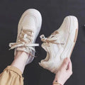 Beige low-top rubber sneakers with height increasing soles and imitation leather lining