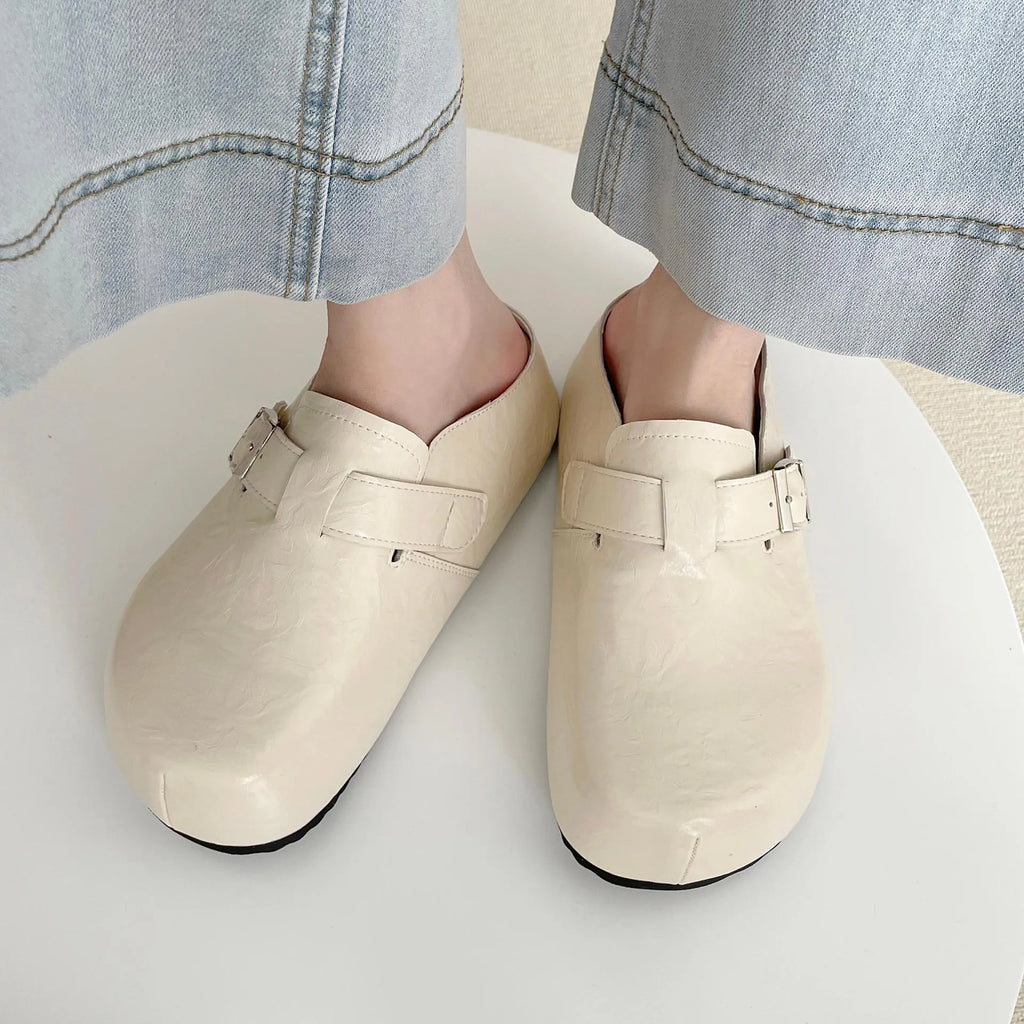 Flat buckle casual sneakers in yellow, creamy-white, silver, and black colours showing round toe and buckle detail.