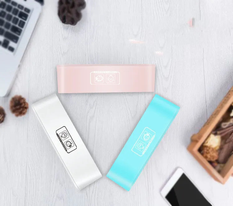 Blue rectangular LED atmosphere light and digital alarm clock on a table.