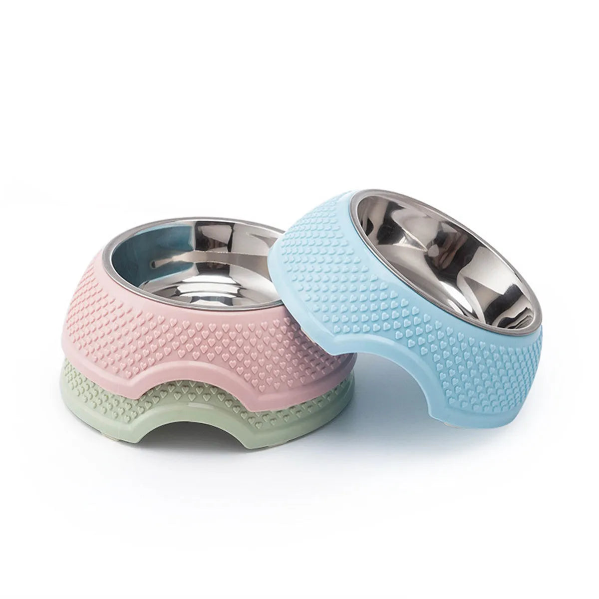 Set of four coloured stainless steel pet bowls with non-slip bases on a floor.