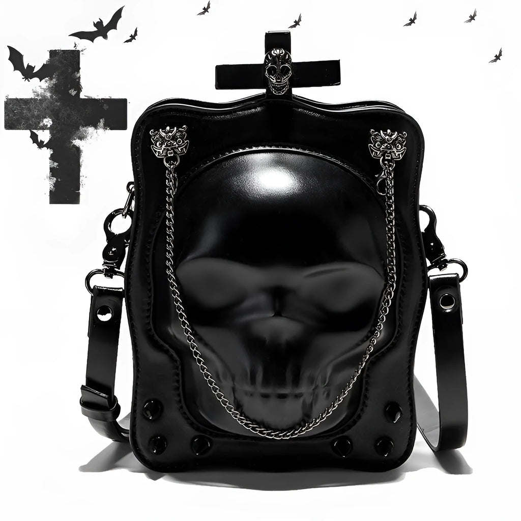 Black gothic mini square messenger bag with skull embossing, stitching, rivets, and chain details on textured PU polyester