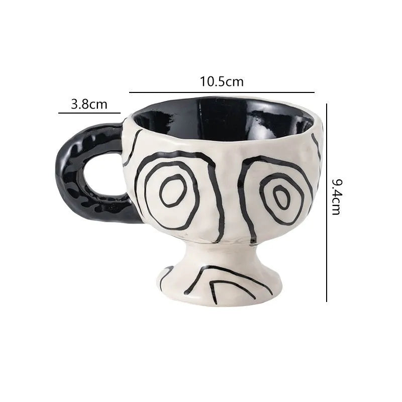 Hand-pinched irregular shaped solid colour ceramic mug on a table, showing its unique form and modern simplicity design.