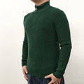 Man wearing a grey half-turtleneck zip-up sweater, showing the front zipper and long sleeves.