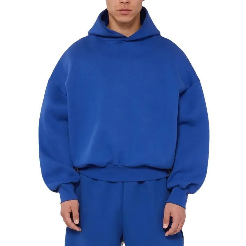 A man's grey fleece-lined pullover sweatshirt with long sleeves, shown on a hanger.