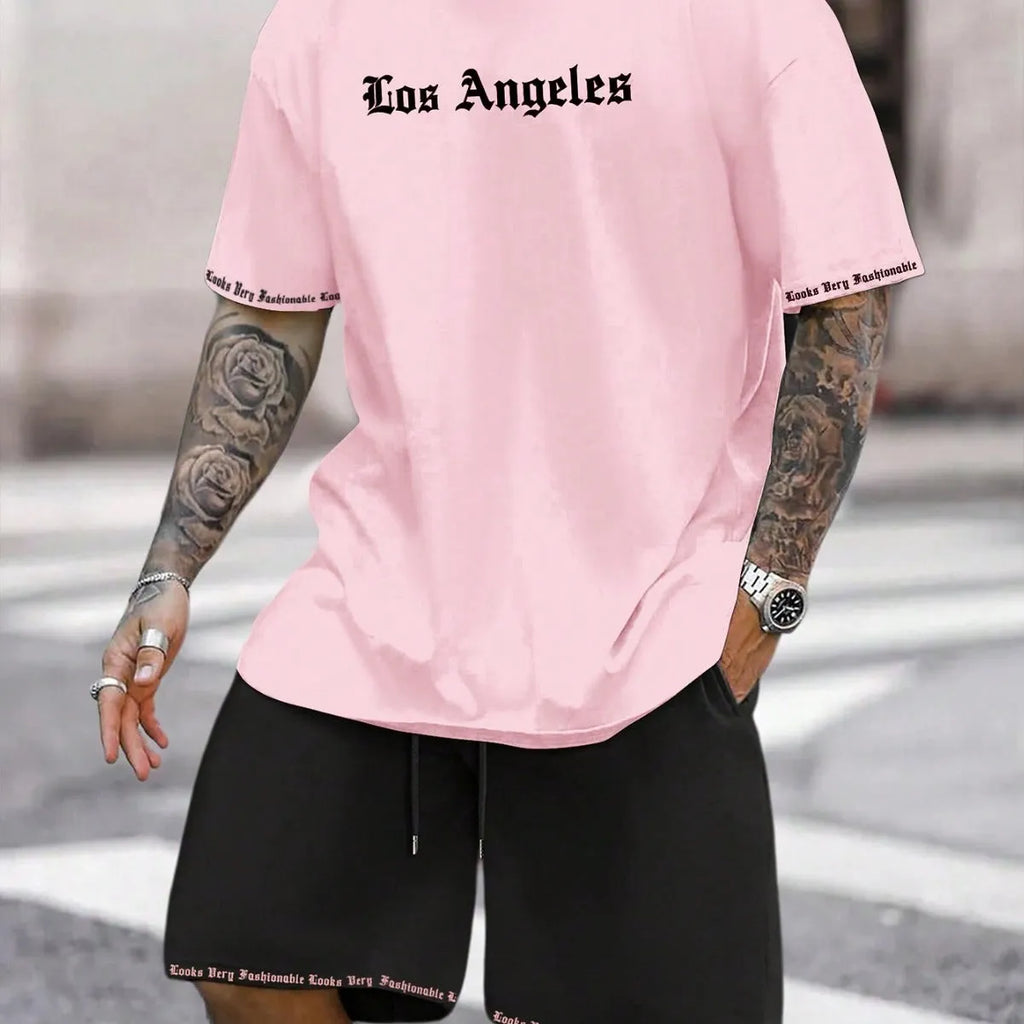 Man wearing a grey short sleeve athletic top and matching shorts from a polyester sportswear set.