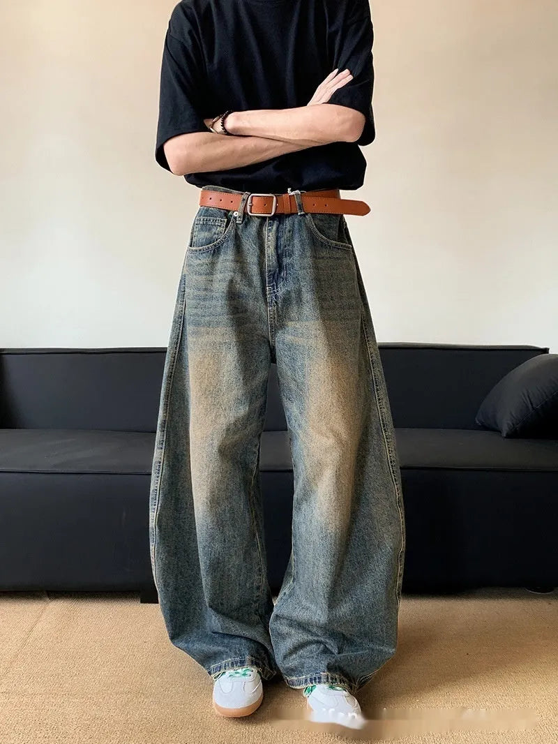 Men's retro blue distressed denim wide-leg trousers showing slim fit and vintage detailing