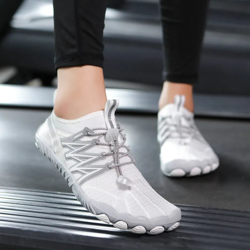 Lightweight indoor fitness training shoes with striped mesh upper and rubber sole in multiple colours.