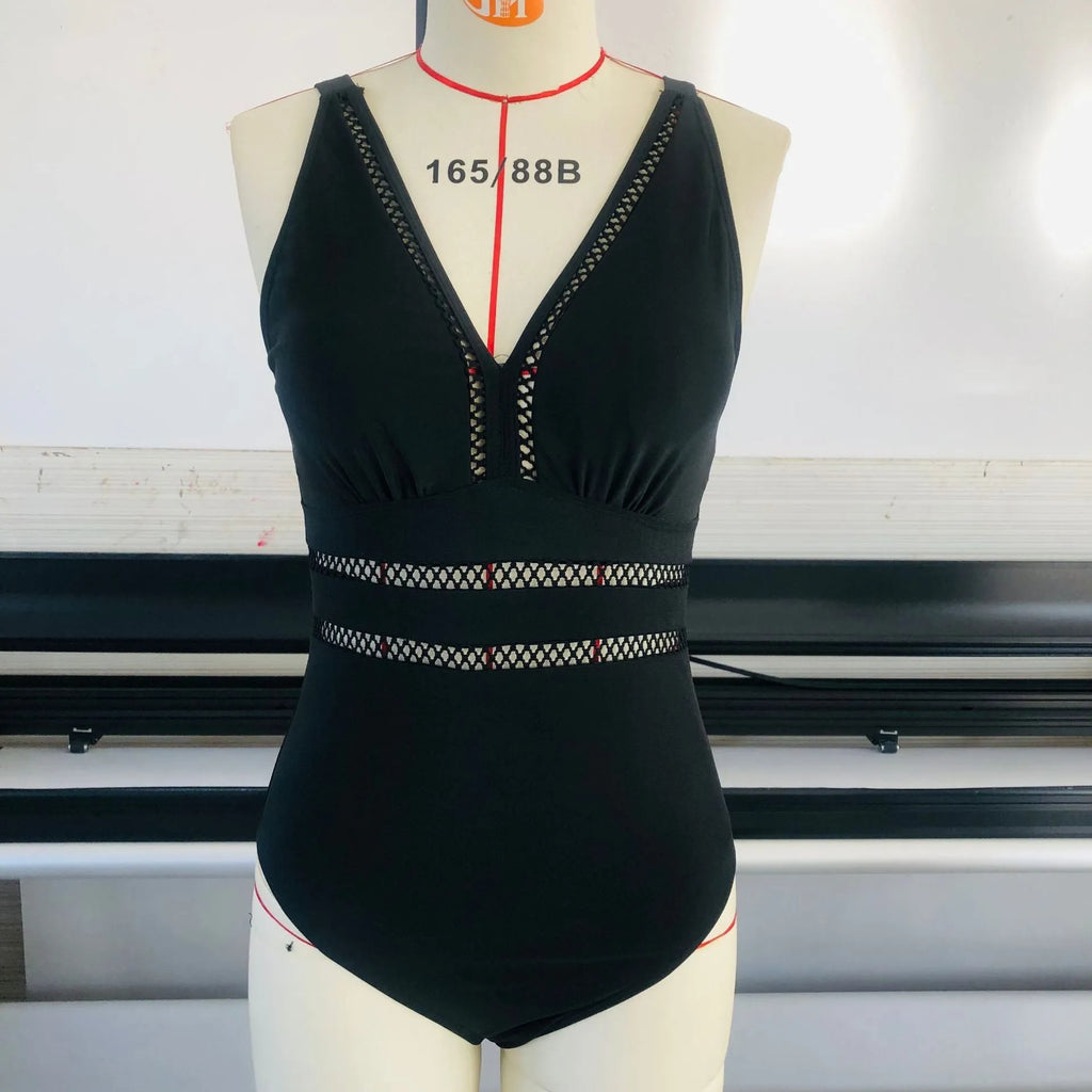 Black plus size women's swimsuit with all-over print pattern and mesh fabric stitching details