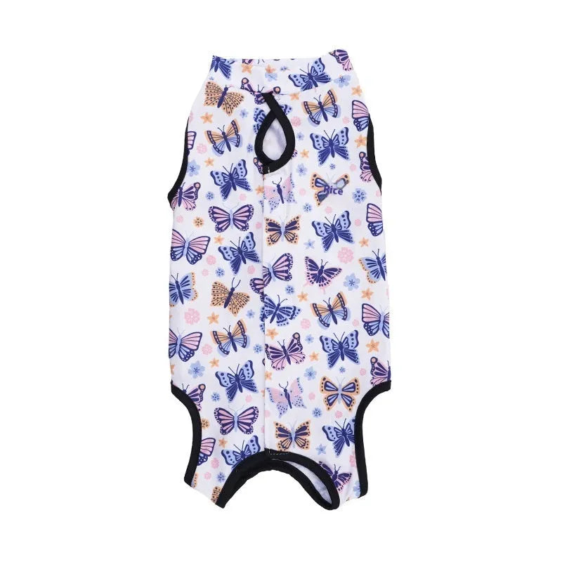 Cat wearing a blue patterned post-surgery recovery suit with velcro fastenings on its back.