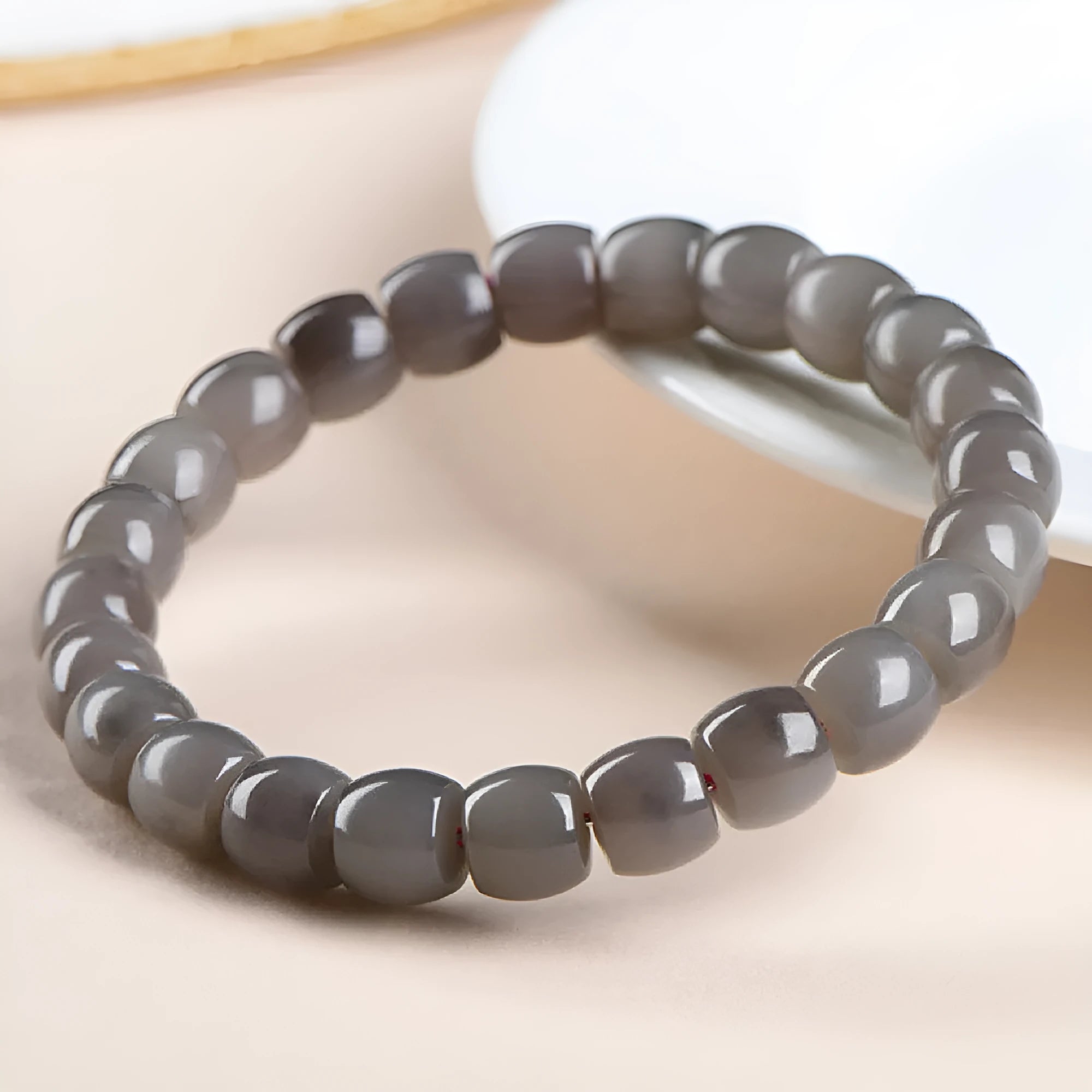 Natural smokey violet Hetian jade straight cut bracelet on a wrist.