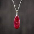 Emperor stone jade water drop pendant necklace with 18K gold plated chain on display.