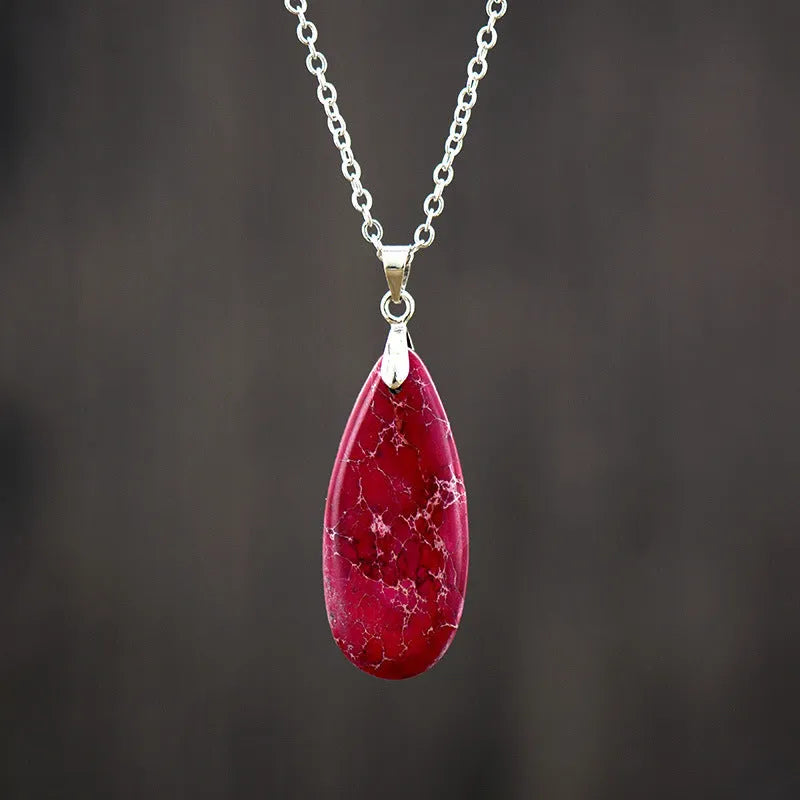 Emperor stone jade water drop pendant necklace with 18K gold plated chain on display.
