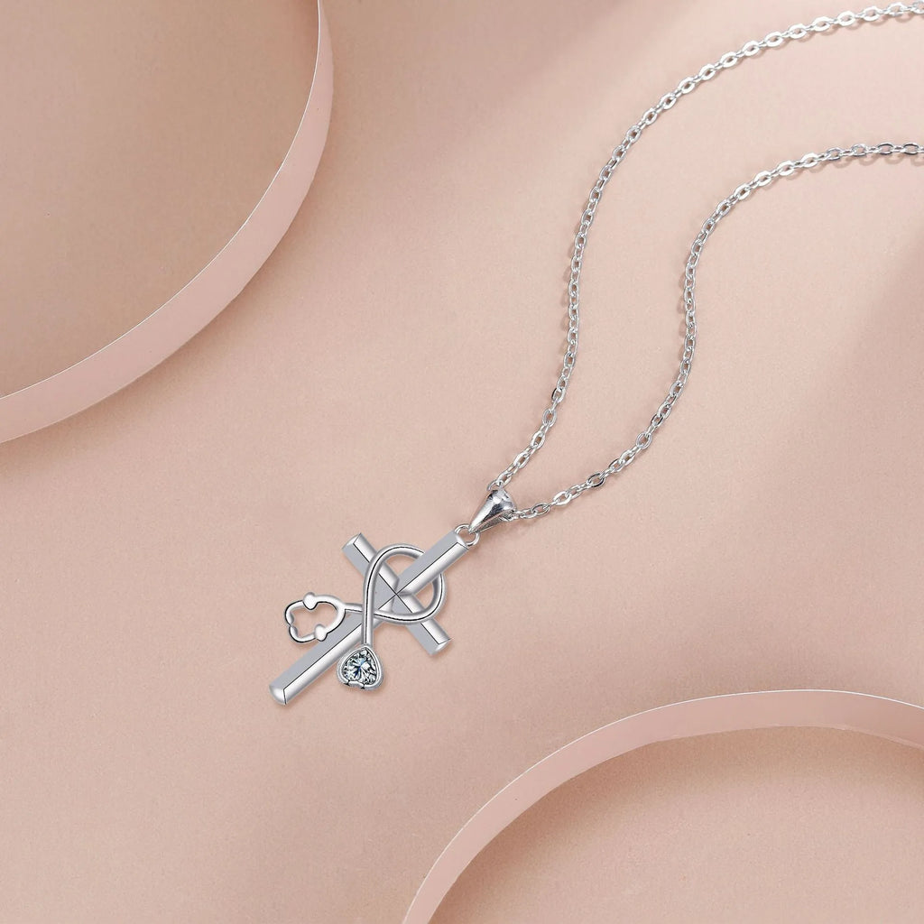 Copper cross stethoscope pendant necklace on a cross chain with electroplated finish.