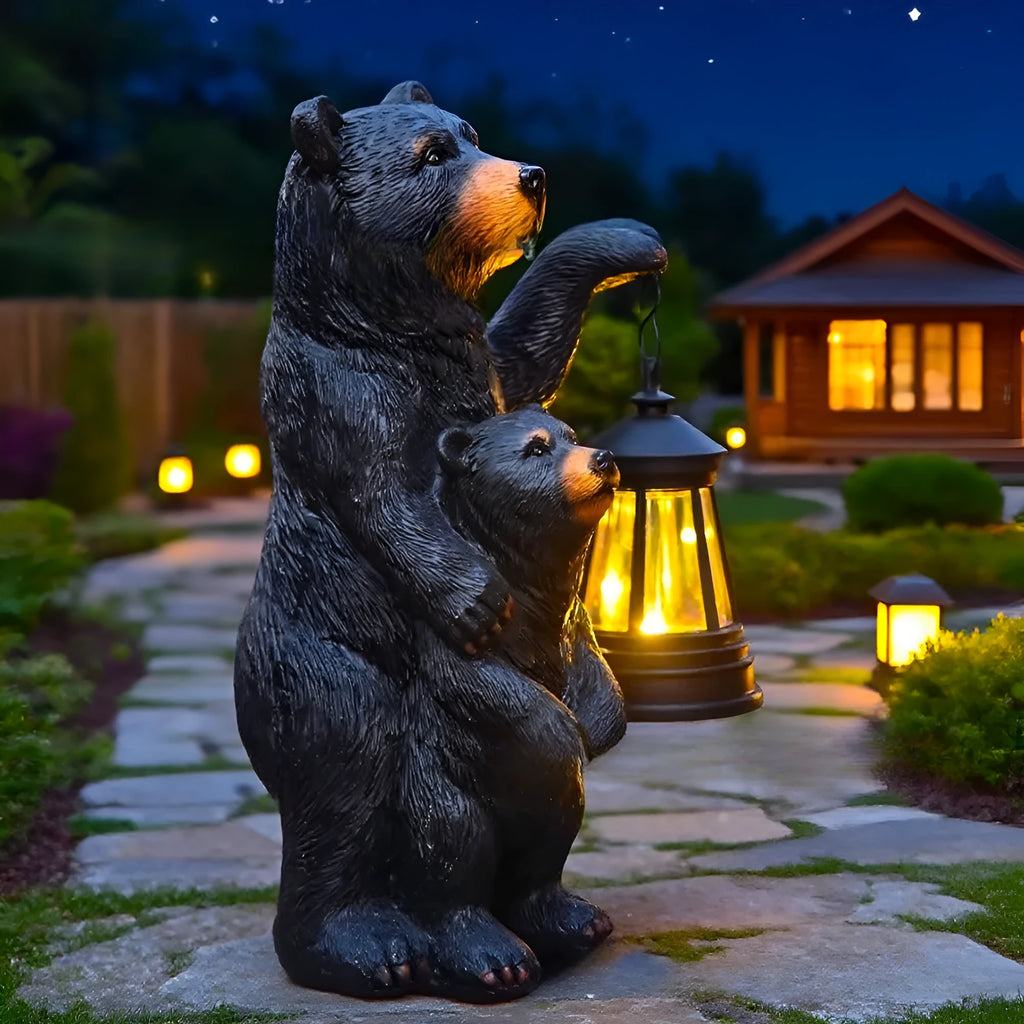 Resin black bear mother and child lantern ornament on a wooden shelf with soft glow