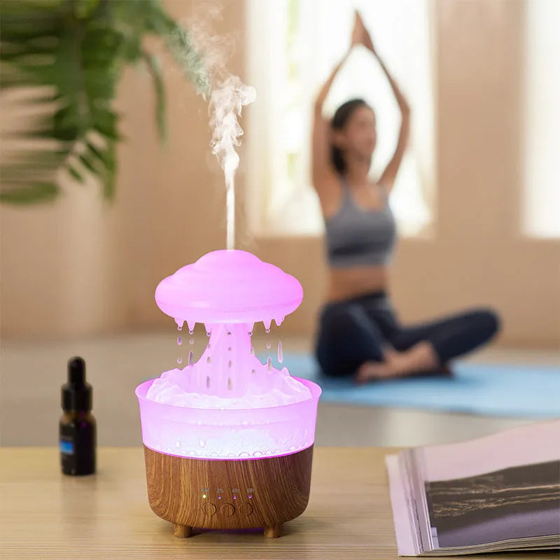 Rain cloud shaped humidifier with wood grain finish emitting mist and glowing with 7-color LED light