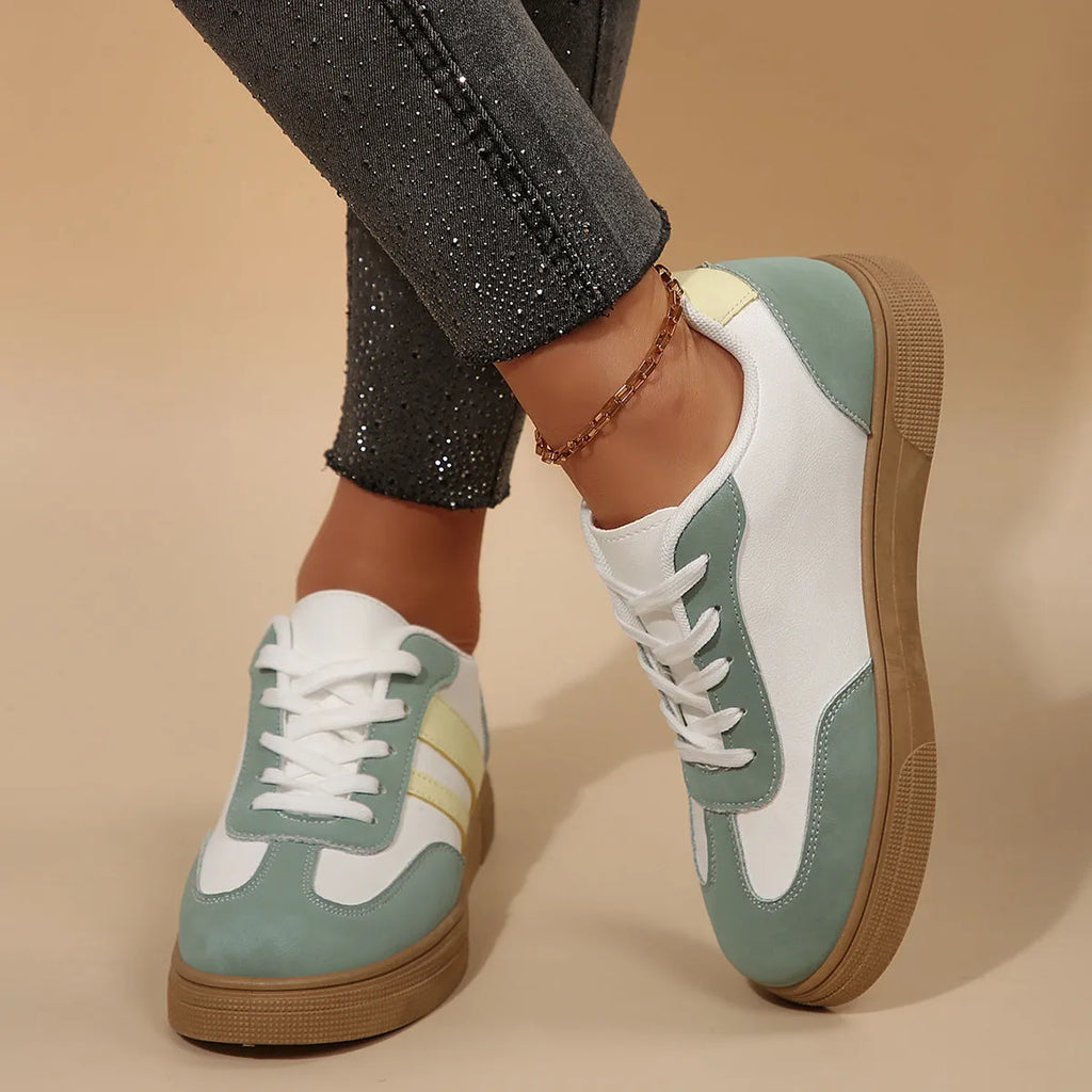 Green retro women's low-top pumps with cross straps, round toe, and flat rubber sole on a white background.