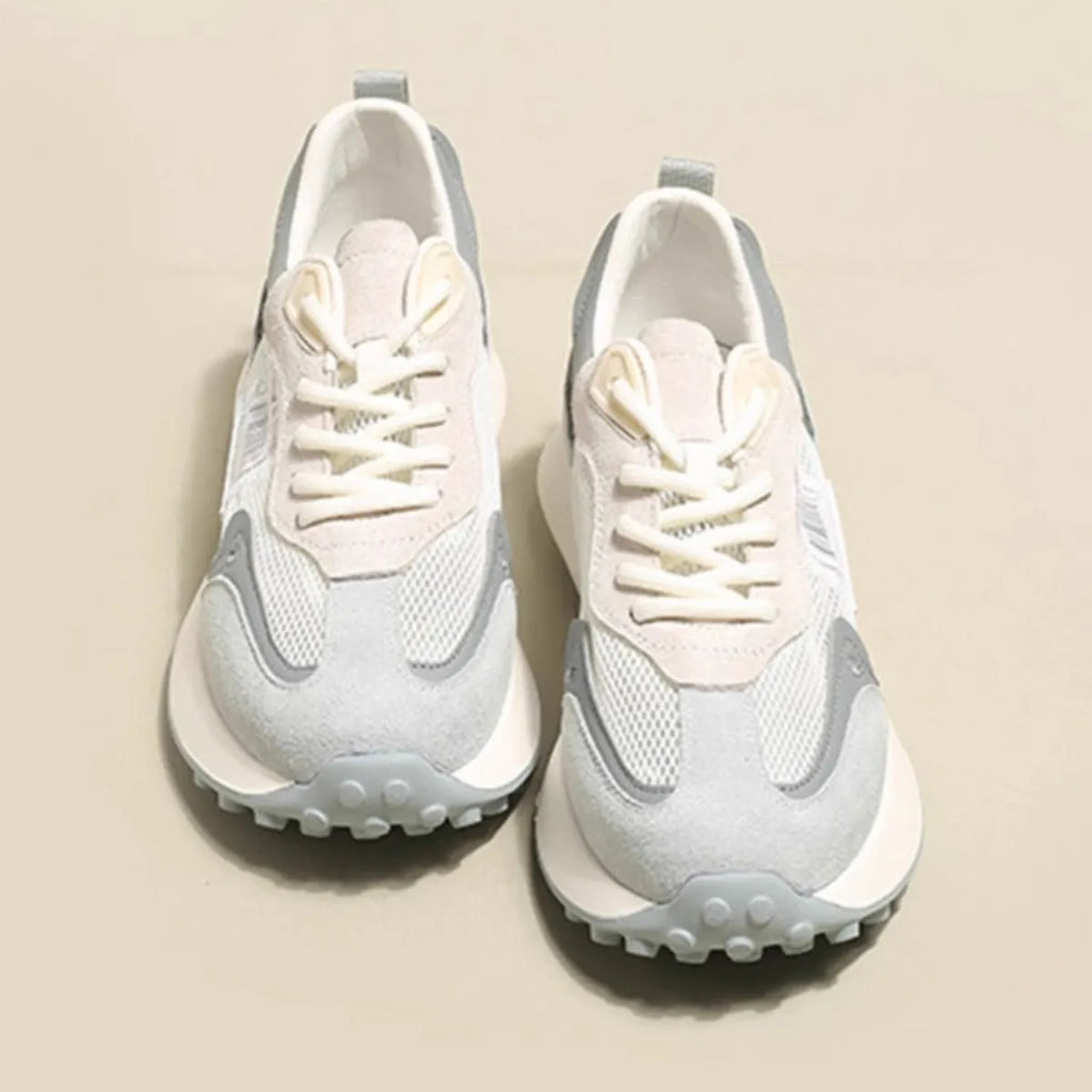 Women's gray retro sneaker with mesh lining and rubber sole on wooden floor