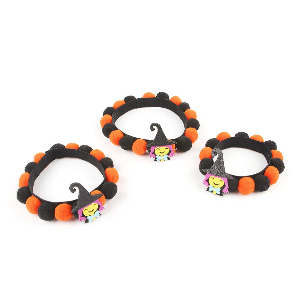 Halloween pet fur ball collar with pumpkin decoration in orange and black festive designs.