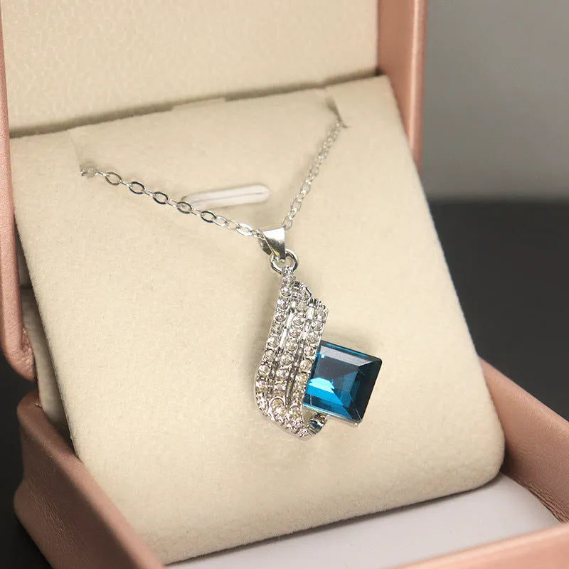 Women's alloy and glass necklace with matching ear studs featuring cross chain design