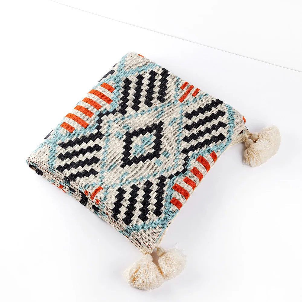 Bohemian-style acrylic sofa cover blanket with tassel trim in a geometric pattern colour option