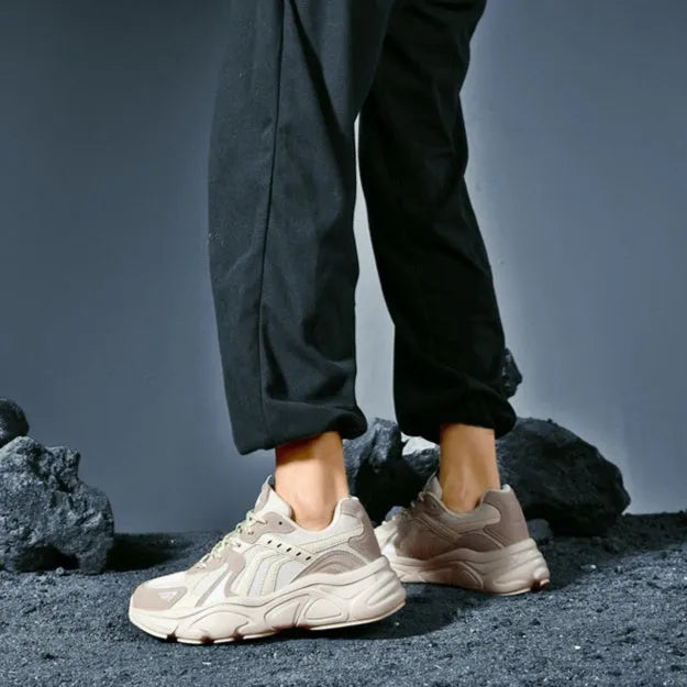 Men's beige and black collapse flat casual sneakers with low heel on a white background.