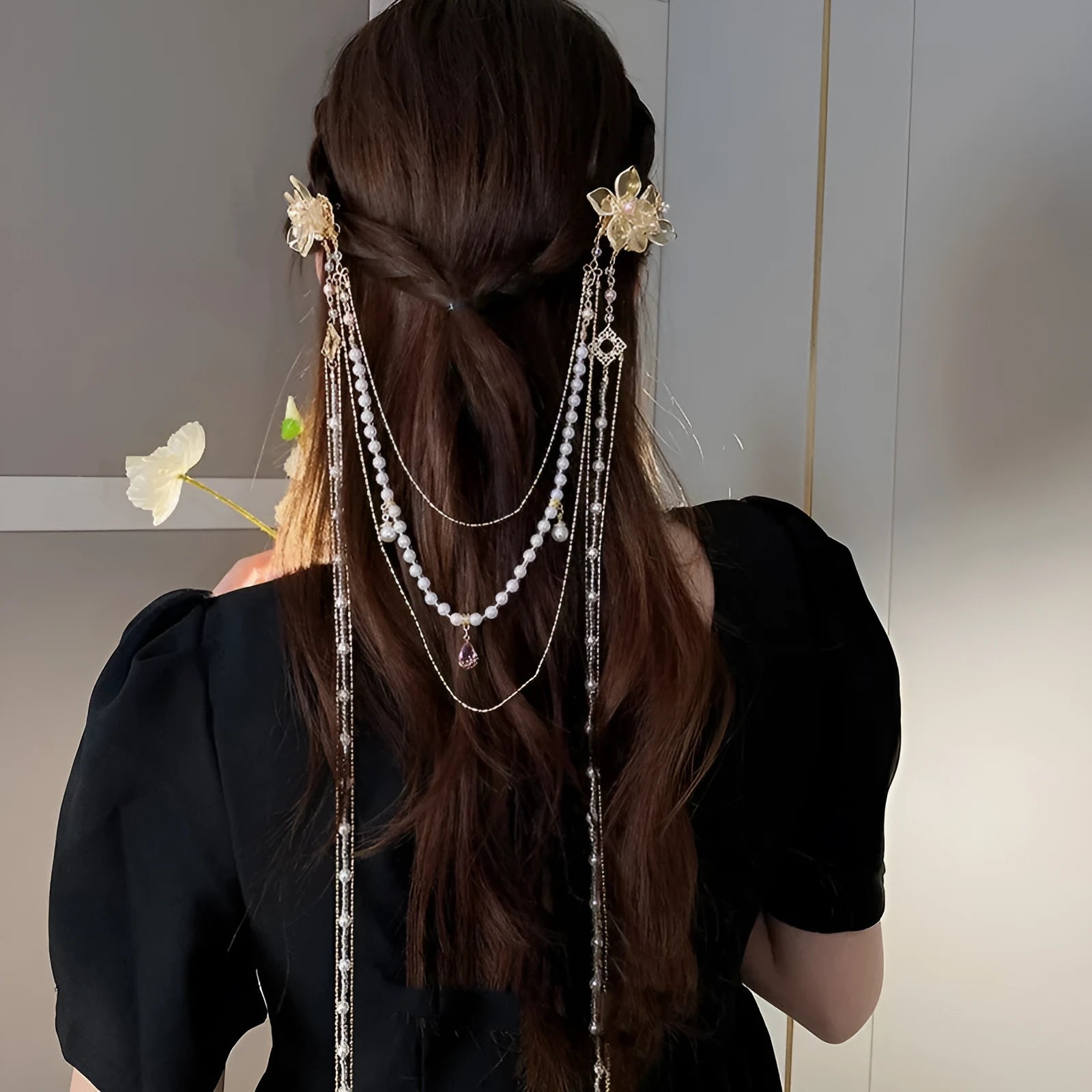 Gold women's hairpin with acrylic pearl flower, long tassels, and diamond-bead grip on a metallic pin.