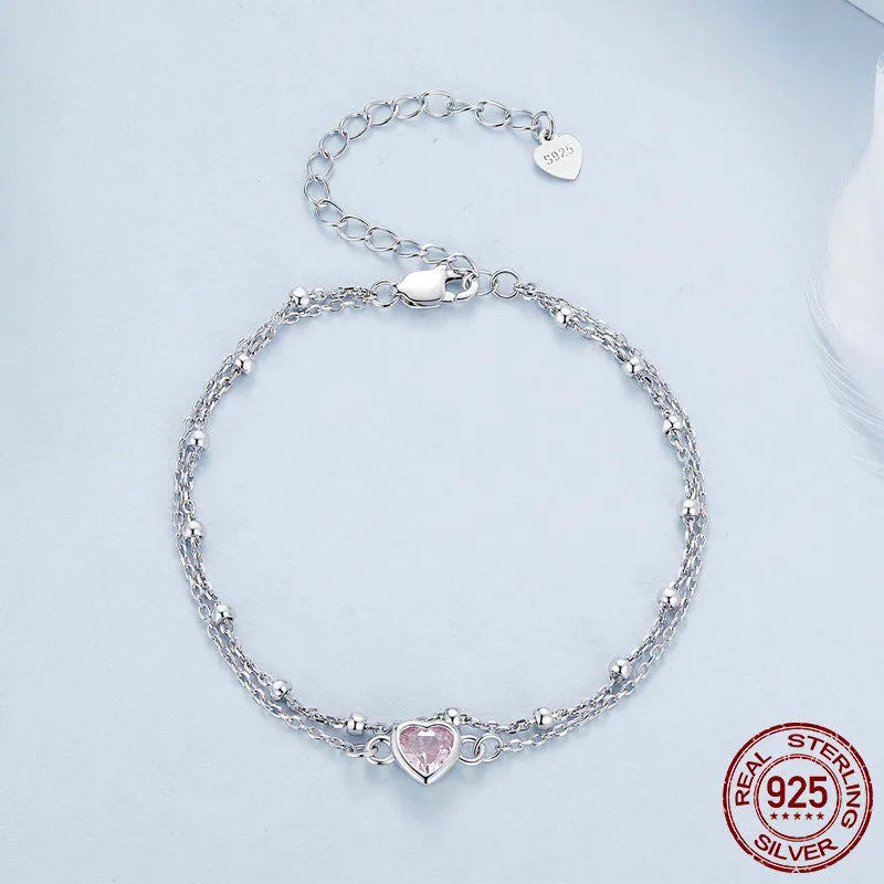 Women's 925 sterling silver bracelet with a small heart-shaped pendant on an adjustable chain.