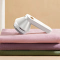 USB rechargeable electric lint remover in white or green with six-leaf stainless steel blade and lint collector container