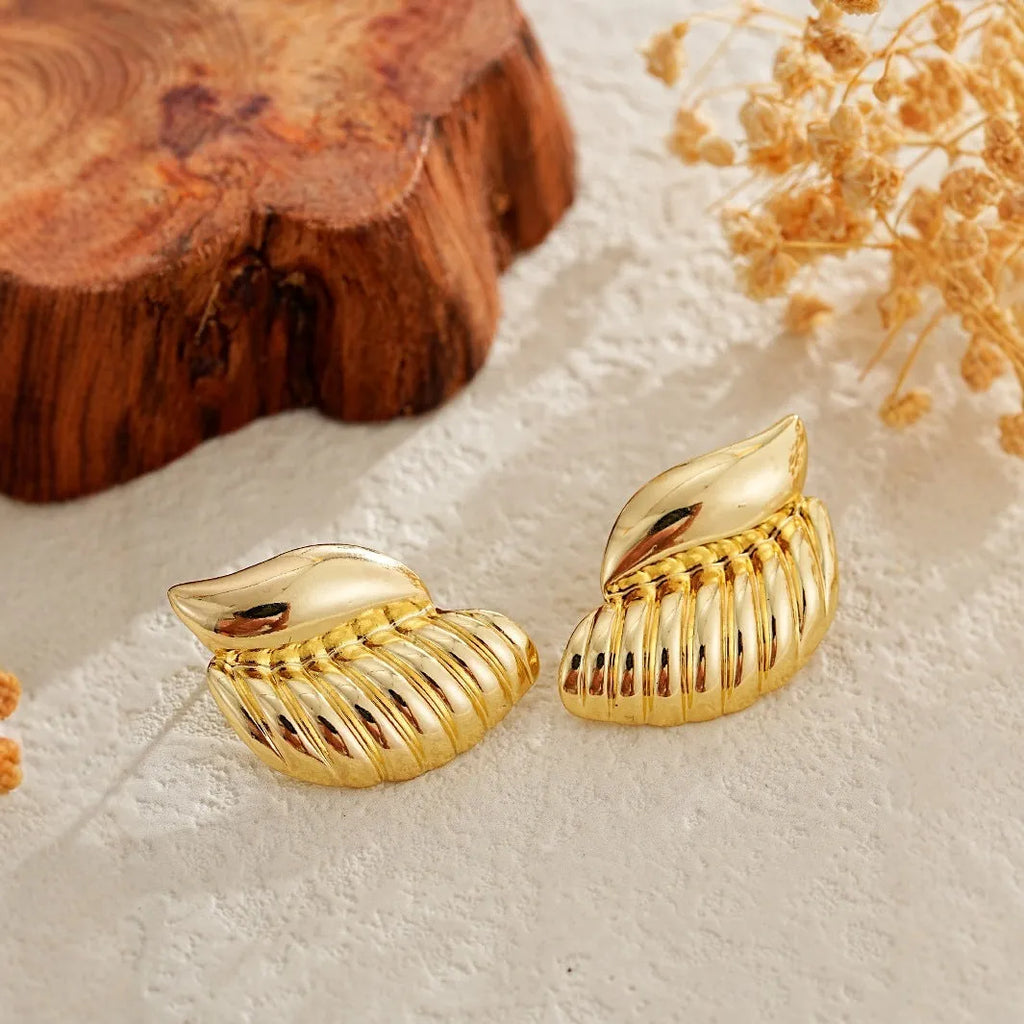 Pair of gold threaded water drop earrings for women on white background