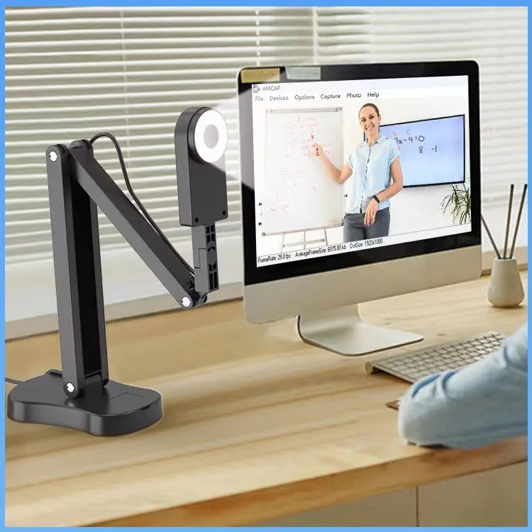 Computer webcam with microphone showing USB cable connection and lens detail