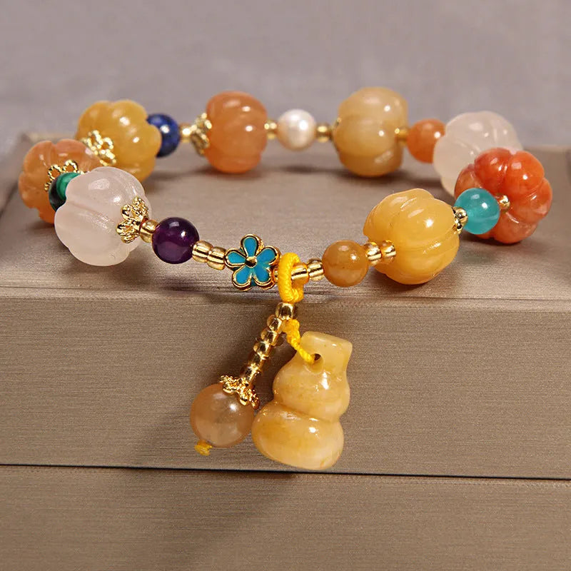 Women's yellow agate crystal bracelet on adjustable gold silk cord.