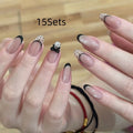Pack of false nails with assorted nail art designs and adhesive tabs for temporary wear.