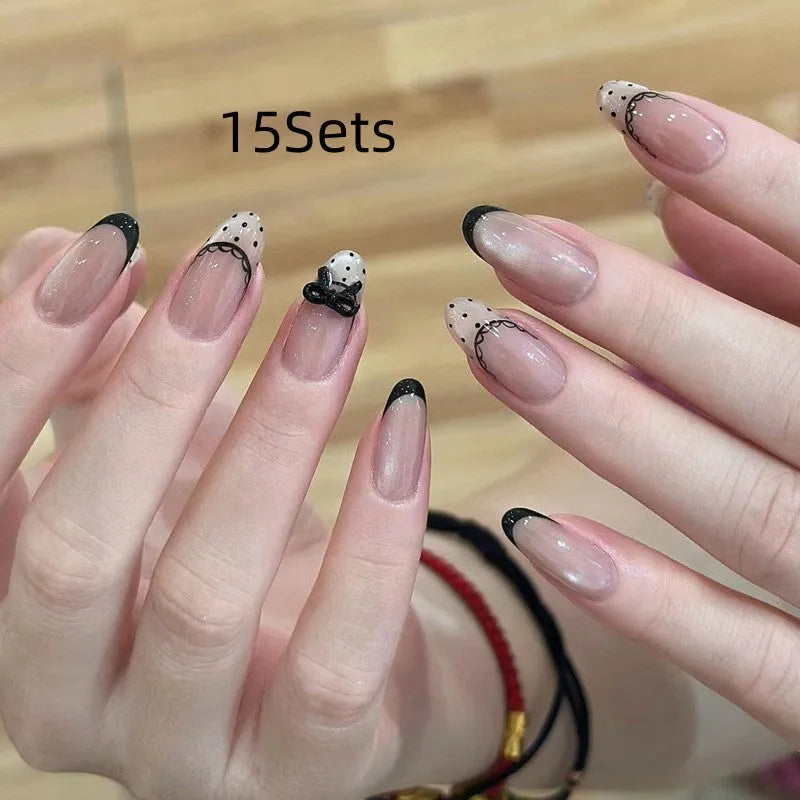 Pack of false nails with assorted nail art designs and adhesive tabs for temporary wear.