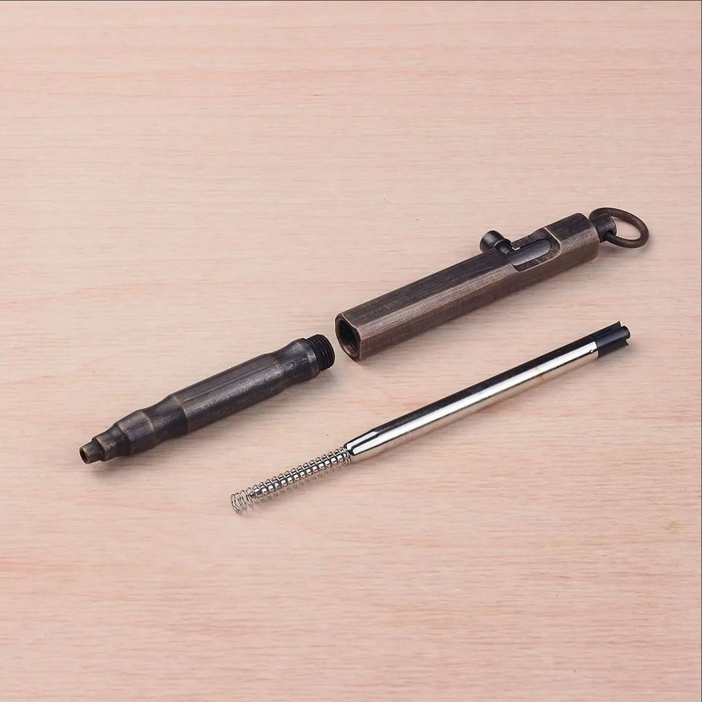 Brass machine gun tactical pen with hexagonal bolt design showing brass natural colour finish
