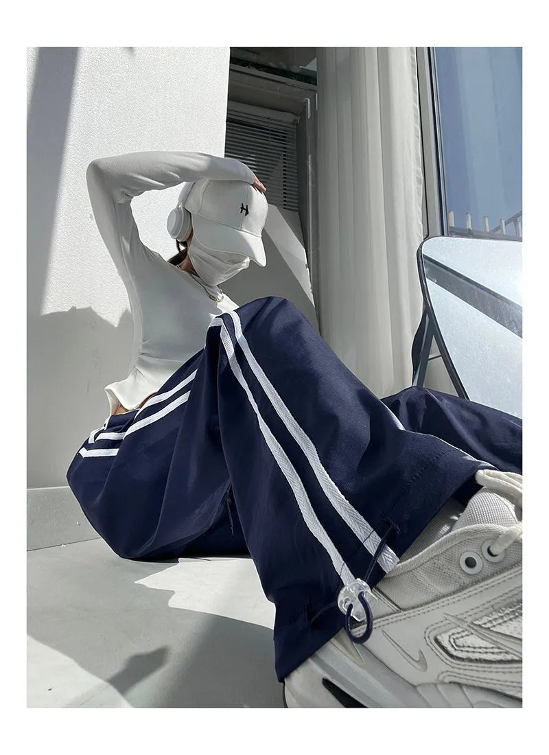 Women's loose straight trousers with ribbon parallel bars detailing in thin draping fabric