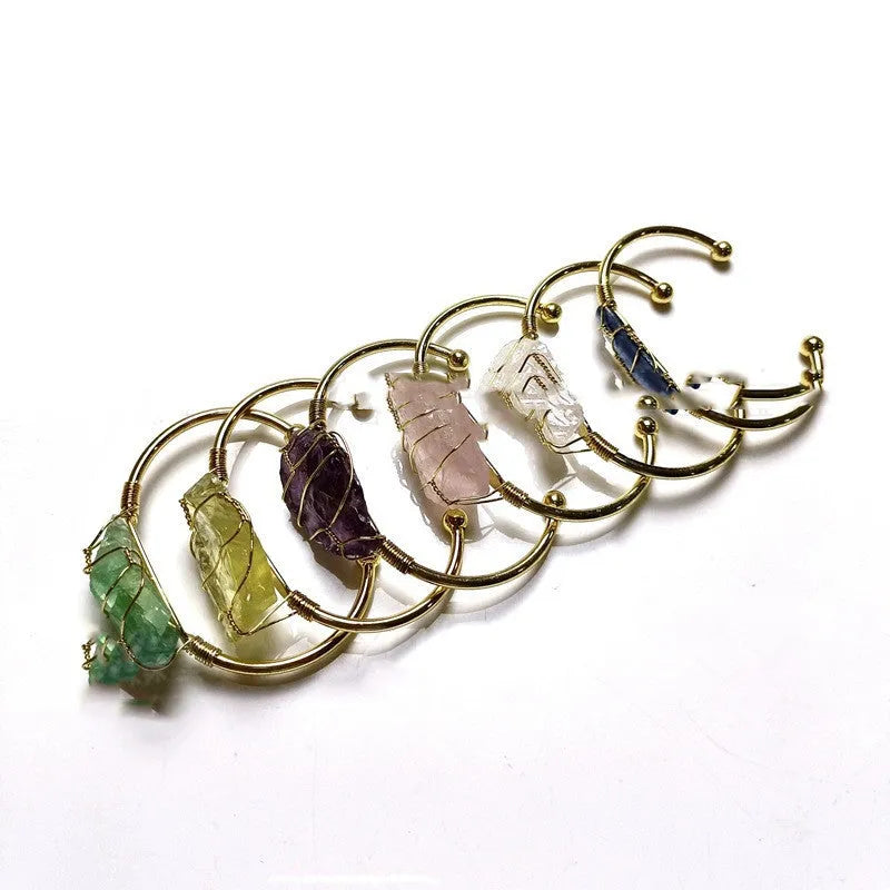 Geometric gold wire bracelet with unshaped natural rough stone crystals in bohemian style.